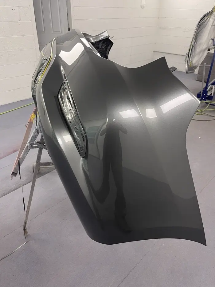 Freshly painted gray quarter panel on a paint stand